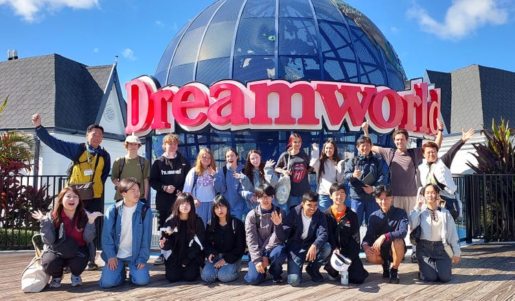 Byron Bay High School Students with students from Okutama standing in front of the Dreamworld sign