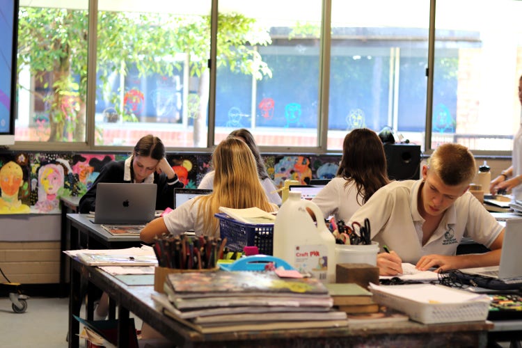 A group of students working in an art classroom