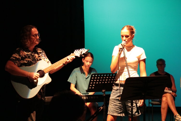 students with their teacher performing music